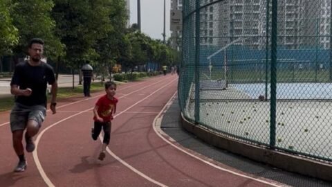 A 7-year-old child and a 27-year-old marathon trainee sprinting side-by-side during a slow-motion sprint session at VHR Sports Academy
