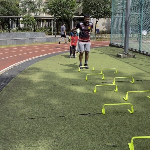 Adult athlete in a mini-hurdle conditioning drill at VHR Sports
