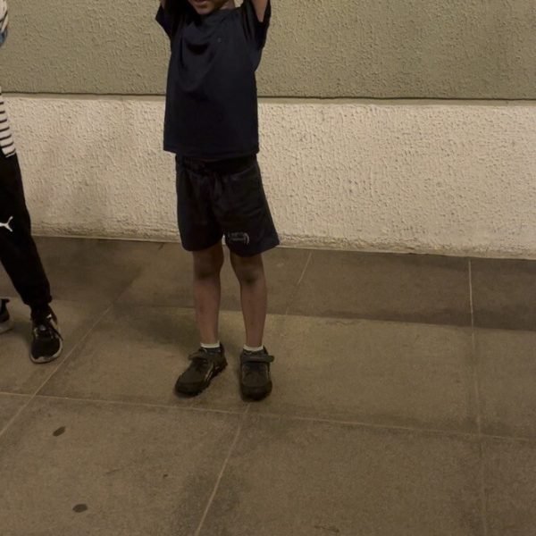 A young athlete celebrating a win with arms raised at VHR Sports