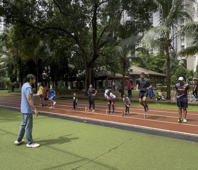 VHR Sports coach guiding young athletes on the running track