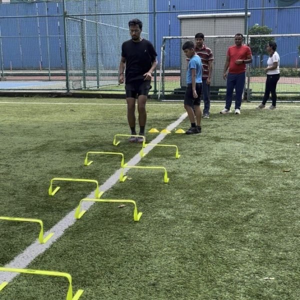 A young athlete jumping a mini-hurdle drill at VHR Sports