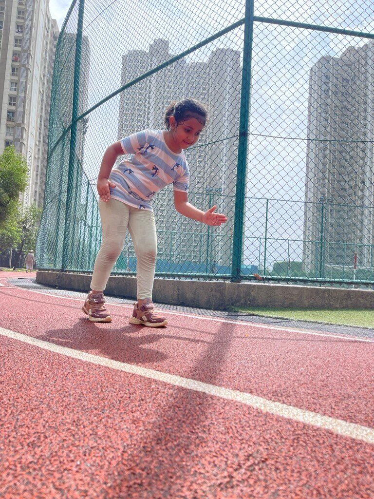 Girl mid-stride in a speed drill on the track at VHR Sports