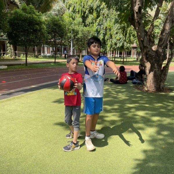 An older VHR Sports athlete encouraging a younger one — teamwork and mentoring