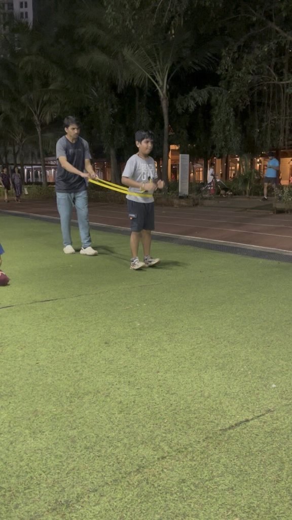 Coach guiding a resistance-band drill — 1-on-1 Performance Plus coaching at VHR Sports