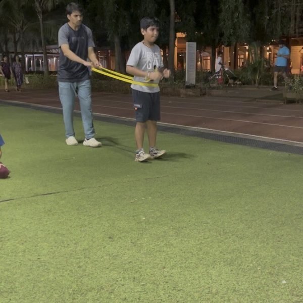 Coach guiding a resistance-band drill — 1-on-1 Performance Plus coaching at VHR Sports
